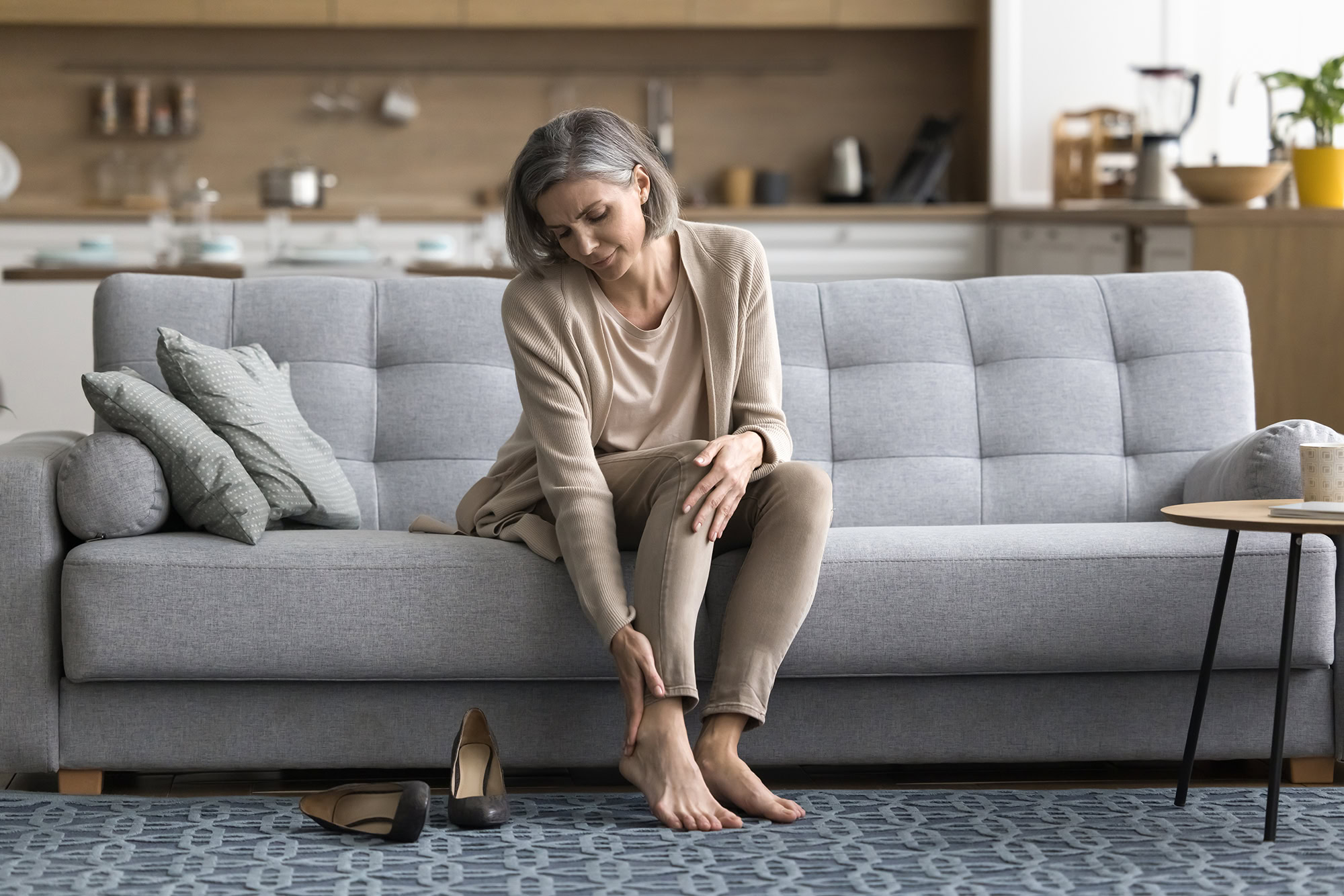 woman holding ankle